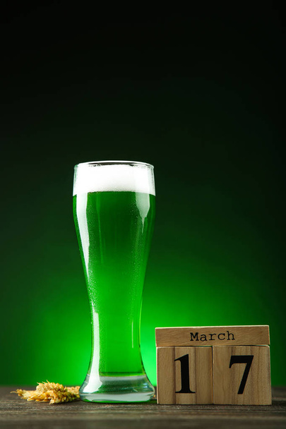 St. Patrick's Day. Green beer in glass with cube calendar and wh - Fotó, kép