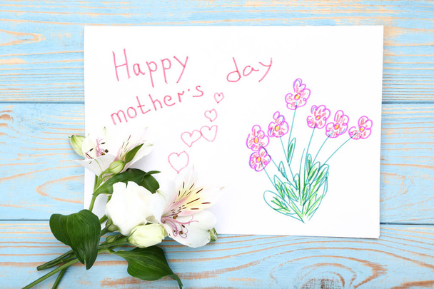 Greeting card for Mothers Day with flowers on blue wooden table - Φωτογραφία, εικόνα