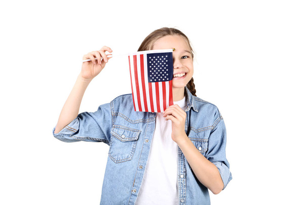 Young girl holding an American flag on white background - Фото, изображение