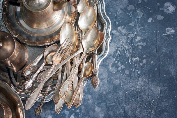Melkhiorovye vintage dining items (tray, kettle, forks, knives, spoons,) top view, horizontal, copy space - Zdjęcie, obraz