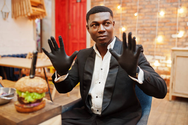 Wearing gloves for food. Respectable young african american man  - Zdjęcie, obraz