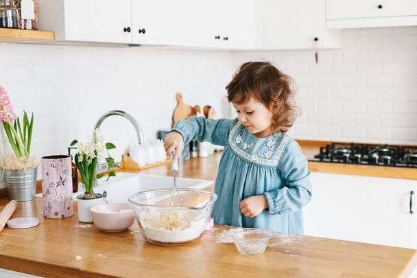 Little girl preparing easter cookies at the kitchen. - Φωτογραφία, εικόνα
