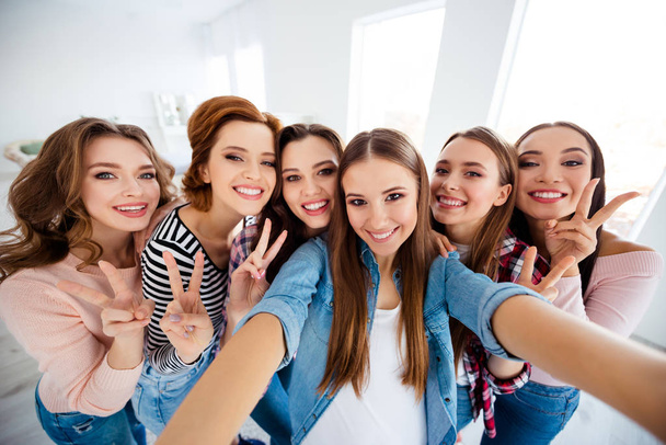 Close up photo beautiful she her ladies one big family roommates make take selfies show v-sign last common photo set all together graduation excited amazed bright white room girls day night indoors - Foto, Imagen