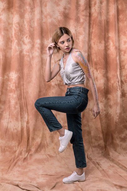 Attractive good looking woman holding one leg up - Fotografie, Obrázek