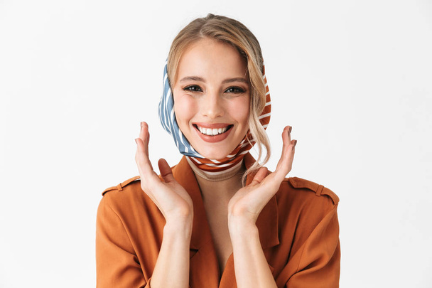 Happy young blonde pretty woman wearing silk scarf posing isolated over white wall background. - Fotó, kép