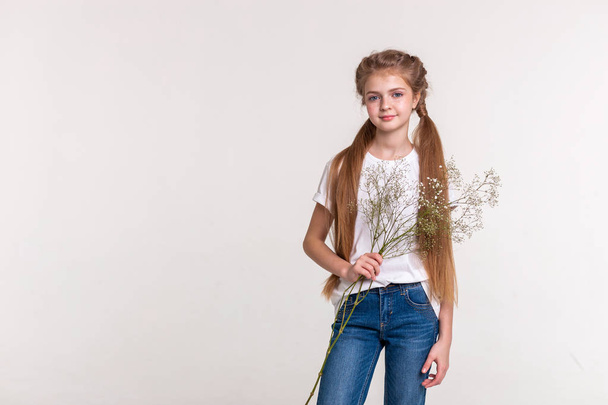 Skinny pretty girl with long light hair wearing blue jeans - Фото, изображение