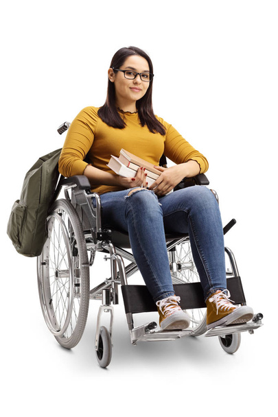 Aufnahme einer Studentin im Rollstuhl mit Büchern auf weißem Hintergrund in voller Länge - Foto, Bild