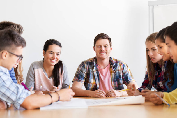 group of smiling students meeting at school - Photo, image