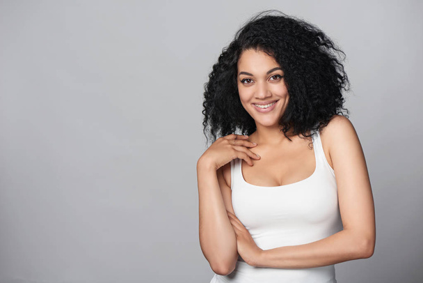 Relaxed mixed race african american - caucasian woman standing in studio - Photo, Image