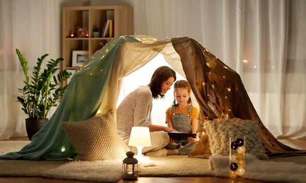 family with tablet pc in kids tent at home - Foto, Imagem