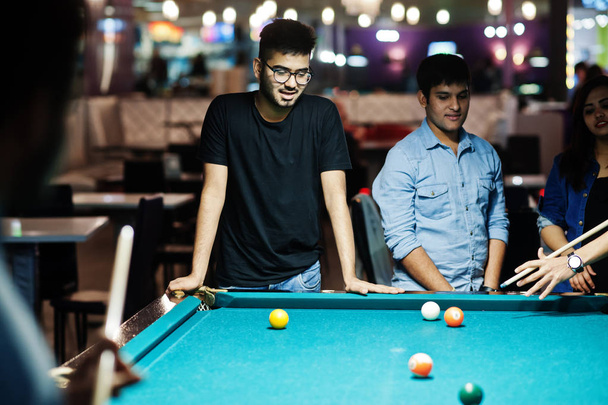 Group of stylish asian friends wear on jeans playing pool billia - Foto, afbeelding