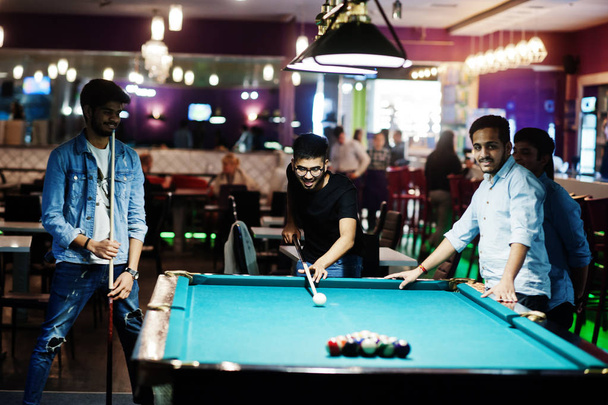 Group of stylish asian friends wear on jeans playing pool billia - Foto, imagen