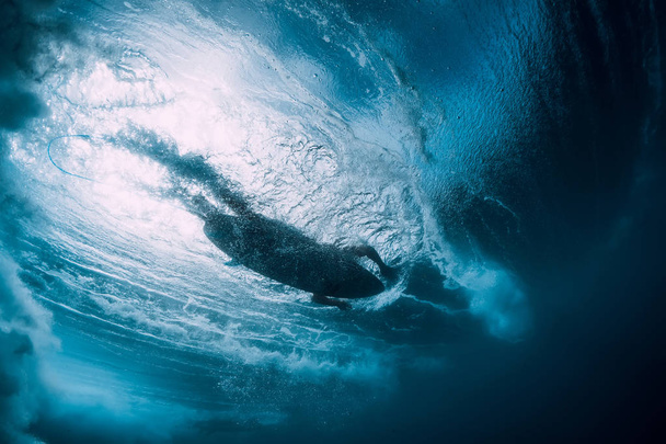 Surfer at surfboard swim in blue ocean, underwater view - Photo, Image