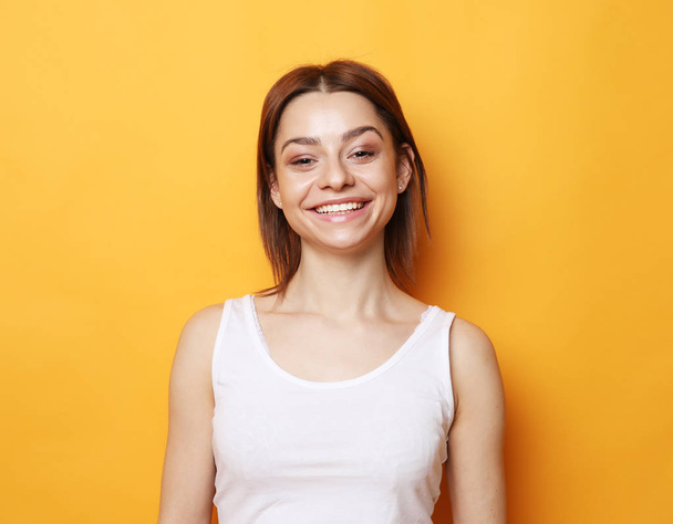 Portrait of young  positive female with cheerful expression - Foto, afbeelding