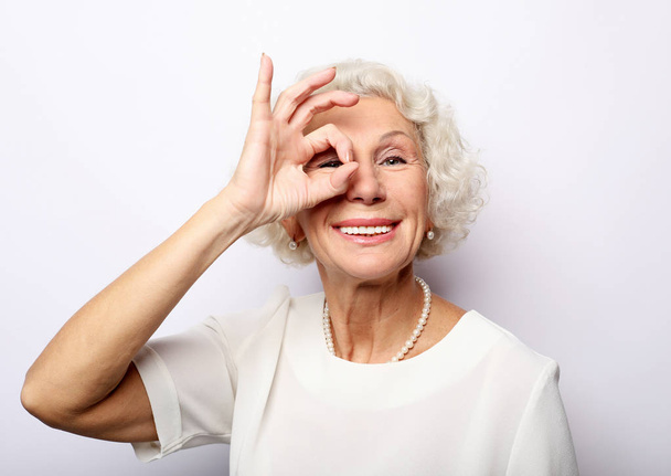 Grey haired old nice beautiful laughing woman. Isolated over vwhite background. Close up. - Foto, Bild