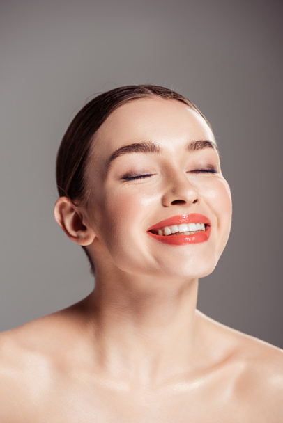 beautiful smiling nude girl with eyes closed posing isolated on grey - Фото, зображення