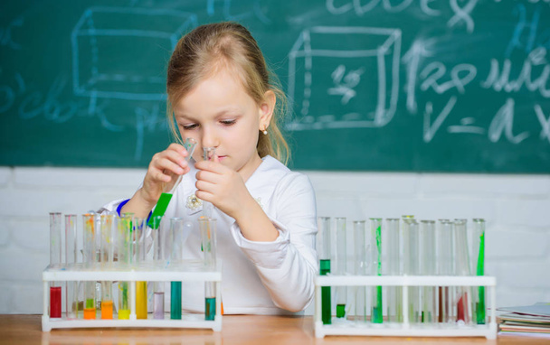 Future scientist. Explore and investigate. School lesson. Interesting approach to learn. Girl cute school pupil play with test tubes and colorful liquids. School chemical experiment. School education - Foto, Imagem