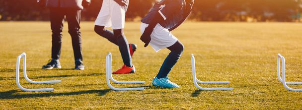 Winter Football Soccer Training Session with Hurdles. Athlete Player Practice Hurdle Jump - Photo, image
