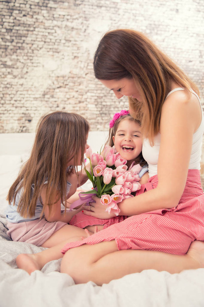 Happy mother's day concept. Mom with twocute young daughters twi - 写真・画像