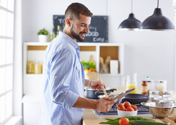 Smiling and confident chef standing in large kitchen - Φωτογραφία, εικόνα