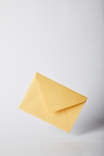 yellow and bright envelope on grey background with copy space  - Foto, afbeelding