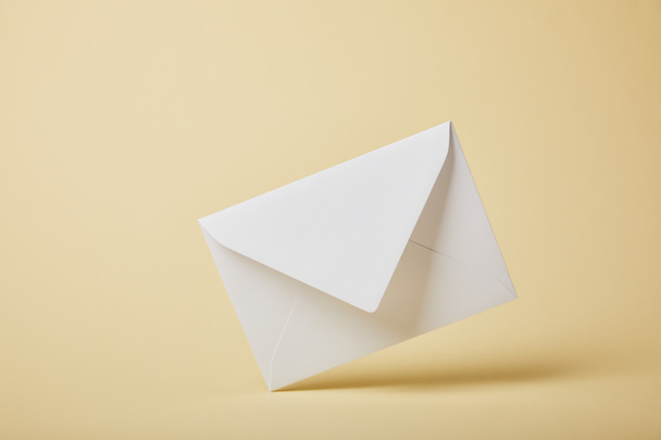 white and blank envelope on yellow background with copy space  - Photo, Image