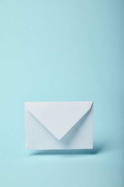 white and empty envelope on blue background with copy space  - Foto, Imagen