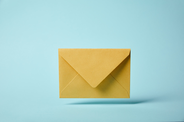 yellow and colorful envelope on blue background with copy space - Foto, immagini