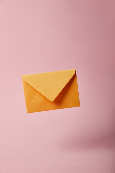 yellow and bright envelope on pink background with copy space - Photo, Image