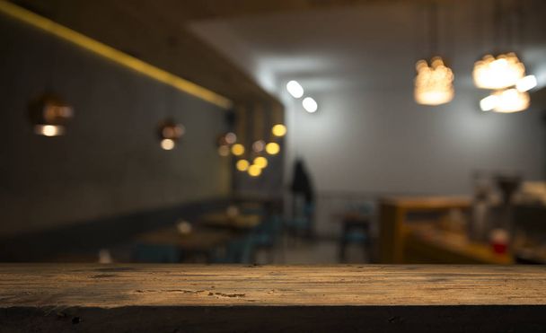 blurred background of bar and dark brown desk space of retro wood - 写真・画像