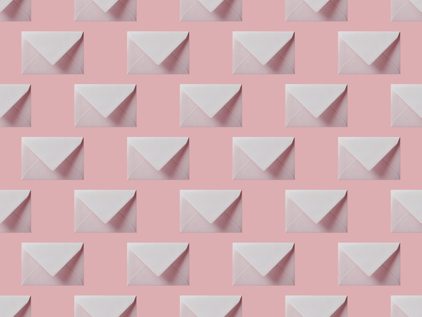 top view of flat lay with white envelopes isolated on pink - Fotoğraf, Görsel