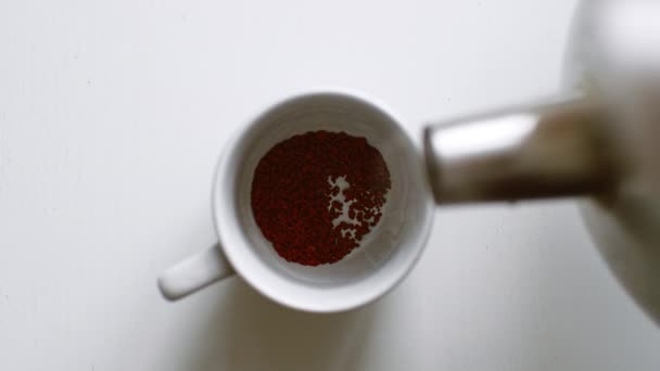 Stream hot water flow pour into instant black coffee - Felvétel, videó