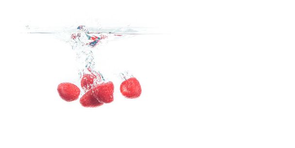Blueberries falling into a water isolated on white background - Photo, Image