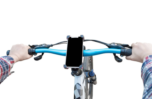 Woman's hand and Smartphone mount on handlebar of mountain bike solated on white background. - Photo, Image