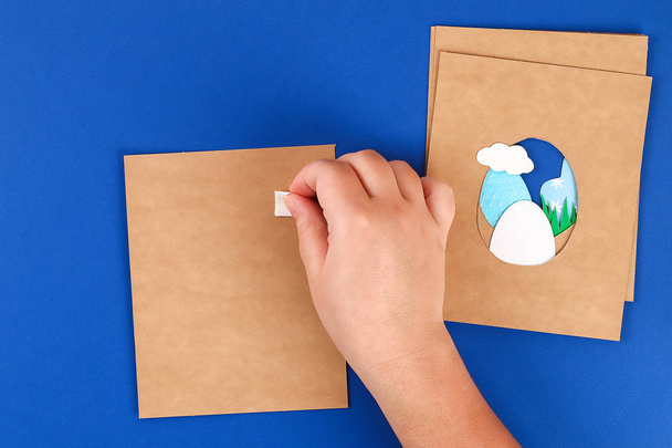 Diy Easter cards from paper. Volume greeting cards with a bunny, egg on blue background. 3d. - Фото, зображення