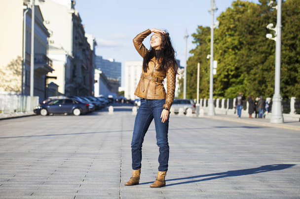Young happy woman in brown leather jacket  - Photo, image
