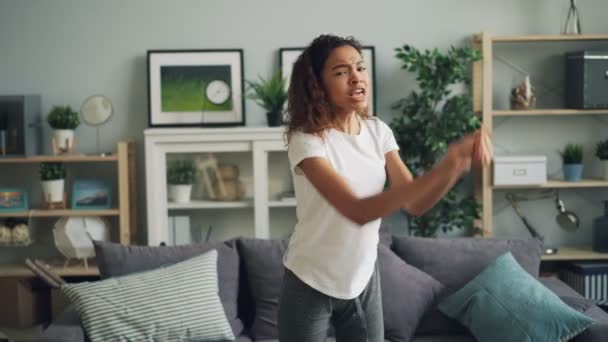 Portrait of mad African American girl shouting, making angry face and gesturing expressing negative emotions standing in modern house then walking away. - Metraje, vídeo