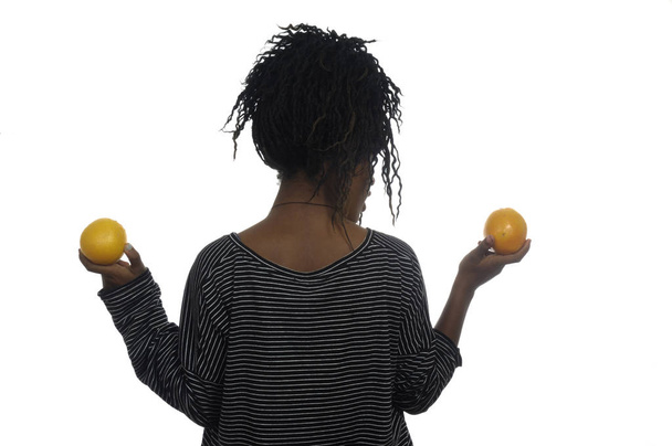 Teenage girl playing with an orange, - Φωτογραφία, εικόνα