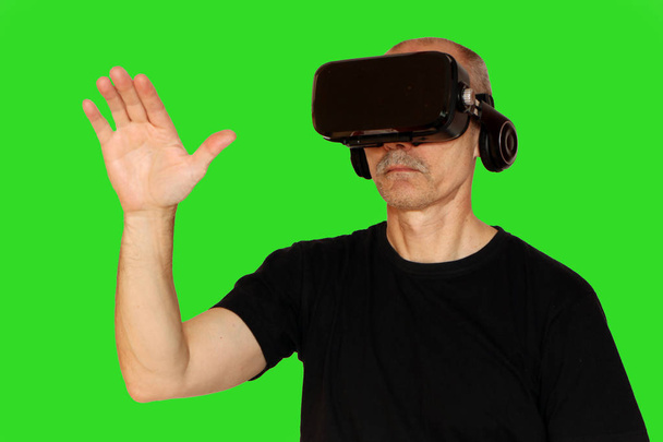 Close-up of a man in a black T-shirt with glasses of virtual rea - Фото, зображення