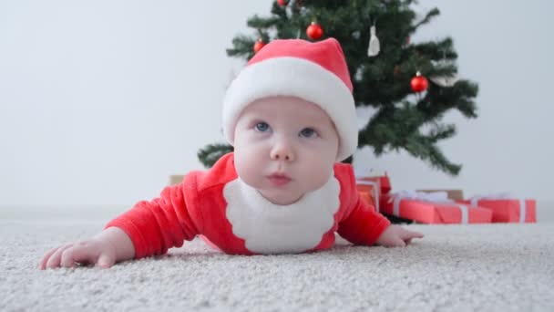 Lindo bebé disfrazado de Santa Claus, buscando un regalo
 - Imágenes, Vídeo
