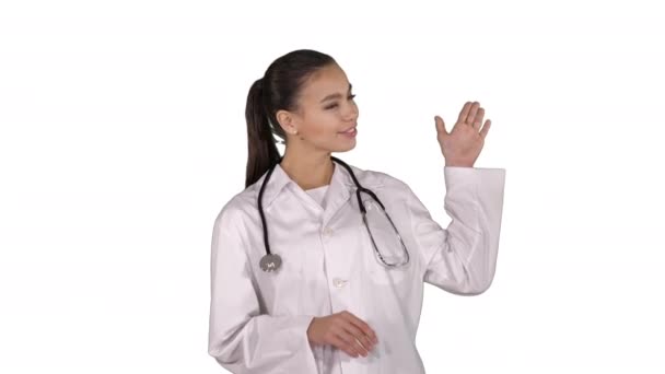 Female doctor showing something with hands extended Presentation on white background. - Video