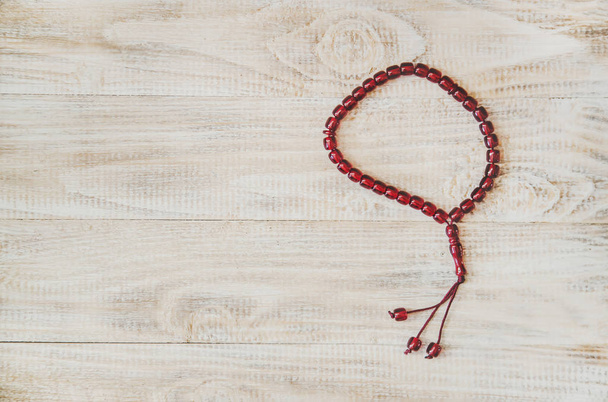 Muslim rosary on wooden background. Selective focus. - Photo, image
