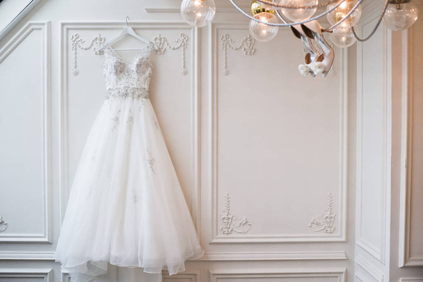 Luxury wedding lace dress in the classic interior of the hotel - Photo, Image