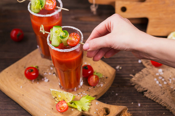 Two glasses of tomato juice decorated with fresh tomatoes, cucum - Фото, изображение