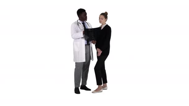 Young woman visiting radiologist for x-ray exam of her brain on white background. - Footage, Video