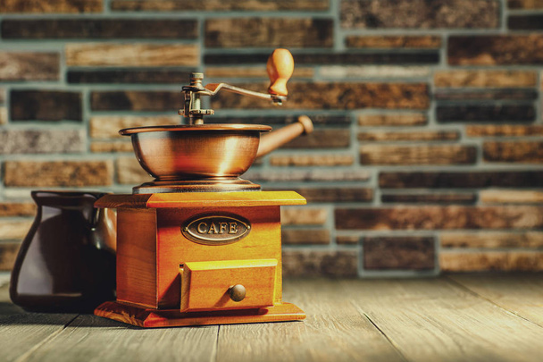 Vintage coffee grinder, turk copper coffee pot and coffee beans  - Fotó, kép