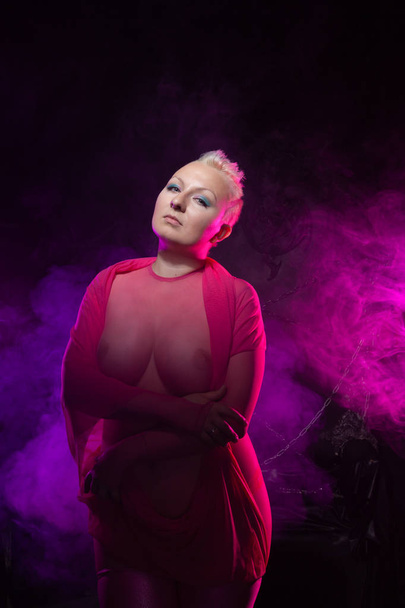 chubby naked woman with short white hair wearing transparent mesh pink catsuit  - Fotografie, Obrázek