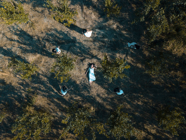 Drone photo of a girl lying in the grass - Photo, Image