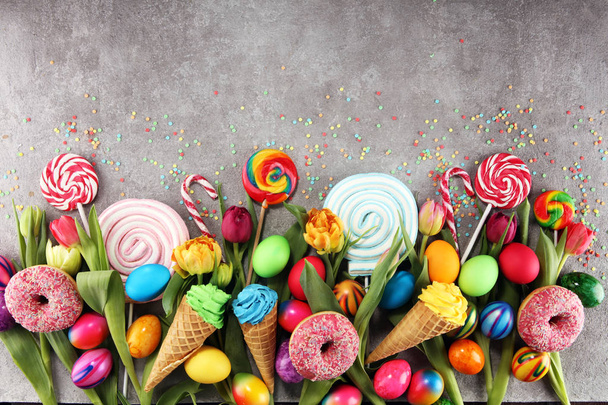 candies with jelly and sugar with tulips and easter eggs. - Photo, Image
