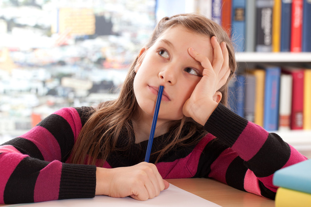 Schoolchild thinking while doing homework - Foto, imagen